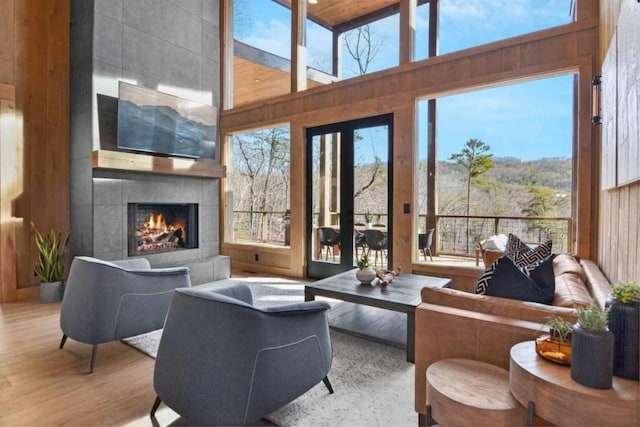 sunroom featuring a tile fireplace