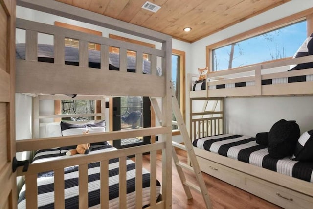 bedroom with hardwood / wood-style flooring and wooden ceiling