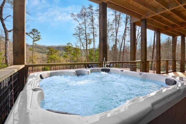 wooden terrace featuring a hot tub