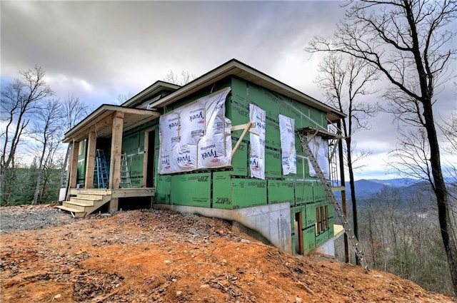 view of side of home featuring a mountain view