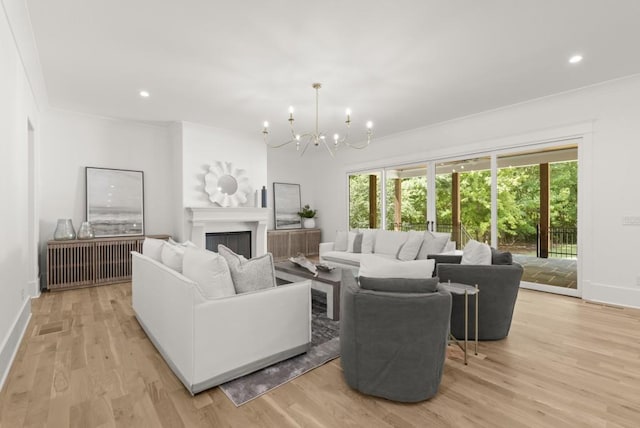 living room with a notable chandelier and light hardwood / wood-style floors