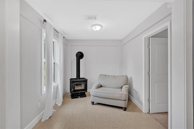 180 Kingston Highway 293 NW, Cartersville, GA 30120 - sitting room featuring healthy amount of natural light, baseboards, a wood stove, and light tile patterned floors