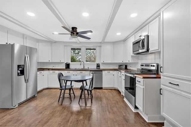 180 Kingston Highway 293 NW, Cartersville, GA 30120 - kitchen with stainless steel appliances, a sink, ceiling fan, white cabinetry, and wood finished floors
