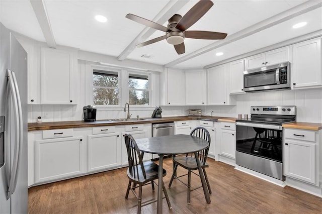 180 Kingston Highway 293 NW, Cartersville, GA 30120 - kitchen featuring stainless steel appliances, butcher block counters, a sink, beam ceiling, and white cabinetry