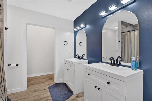 180 Kingston Highway 293 NW, Cartersville, GA 30120 - full bathroom featuring wood finished floors, two vanities, baseboards, and a shower with shower curtain