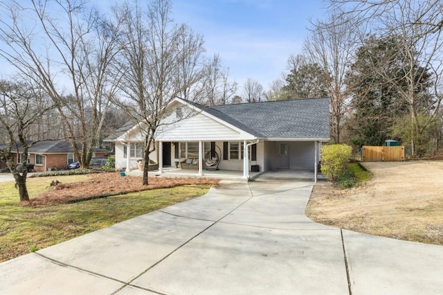 ranch-style house featuring a front lawn, a carport, and a porch