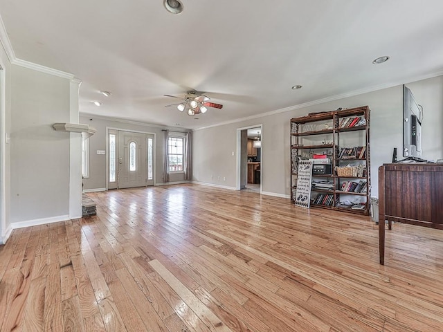 unfurnished living room featuring light wood-type flooring, ornamental molding, and ceiling fan