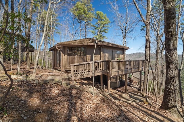 rear view of house with a wooden deck