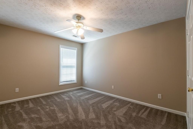 empty room featuring ceiling fan, a textured ceiling, visible vents, baseboards, and dark colored carpet