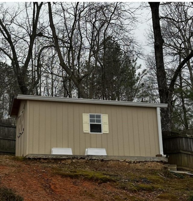 view of outbuilding featuring fence