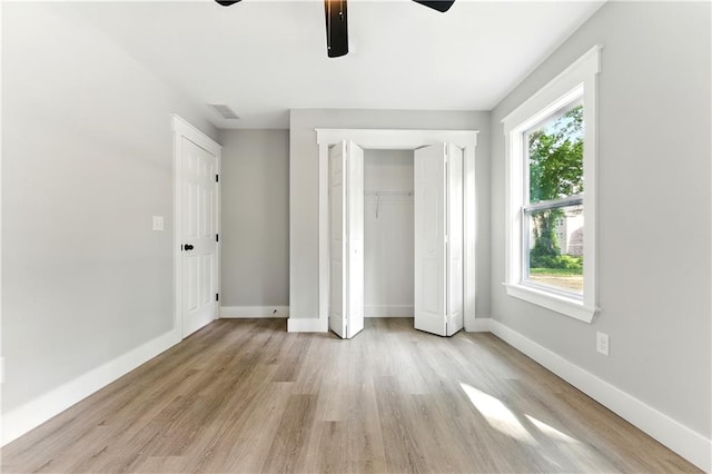 124 Sims Dr, Hiram, GA 30141 - unfurnished bedroom with multiple windows, light wood-type flooring, baseboards, and a closet