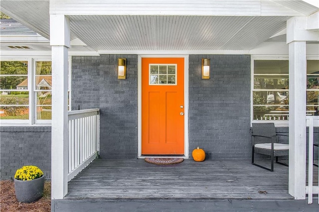 view of exterior entry with covered porch