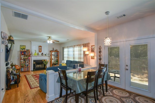 574 Friars Head Dr, Suwanee, GA 30024 - dining area featuring wood finished floors, a fireplace, french doors, and ceiling fan