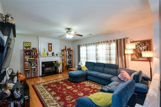574 Friars Head Dr, Suwanee, GA 30024 - living area featuring a fireplace with flush hearth, ceiling fan, and wood finished floors