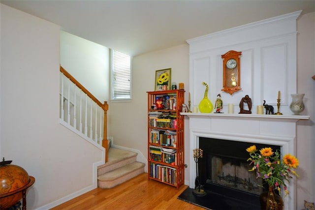 574 Friars Head Dr, Suwanee, GA 30024 - living area with wood finished floors, stairway, and a fireplace