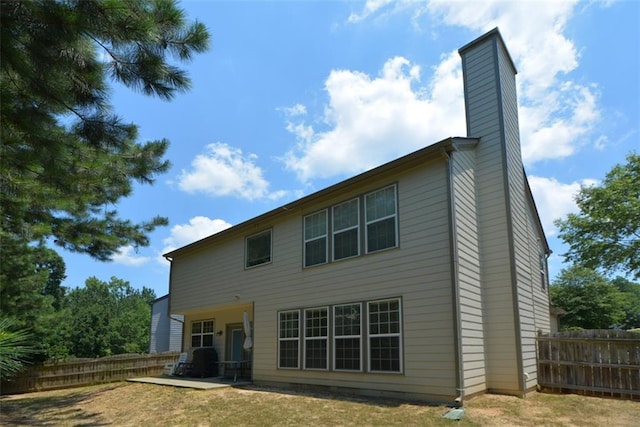 574 Friars Head Dr, Suwanee, GA 30024 - rear view of property with a chimney and a patio