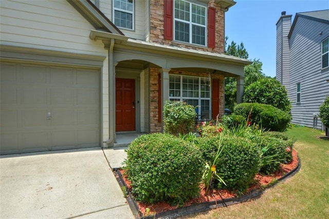 574 Friars Head Dr, Suwanee, GA 30024 - property entrance with stone siding and concrete driveway