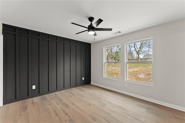 unfurnished room with ceiling fan and light wood-type flooring