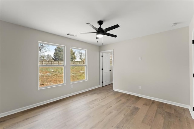 empty room with ceiling fan and light wood-type flooring