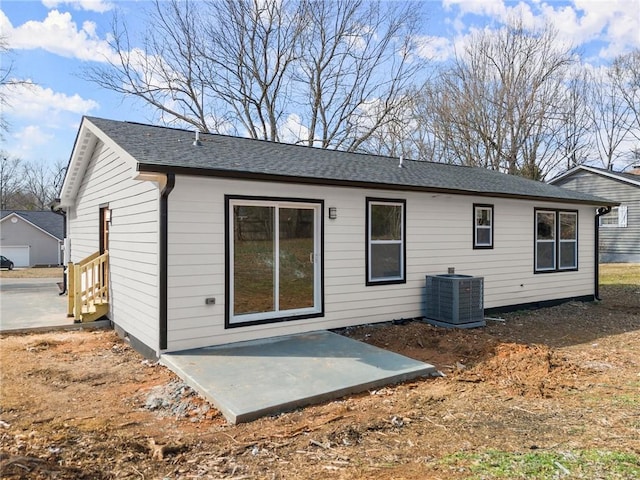 rear view of property with central AC unit and a patio area