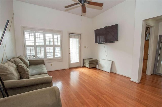 living room featuring ceiling fan and light wood-type flooring