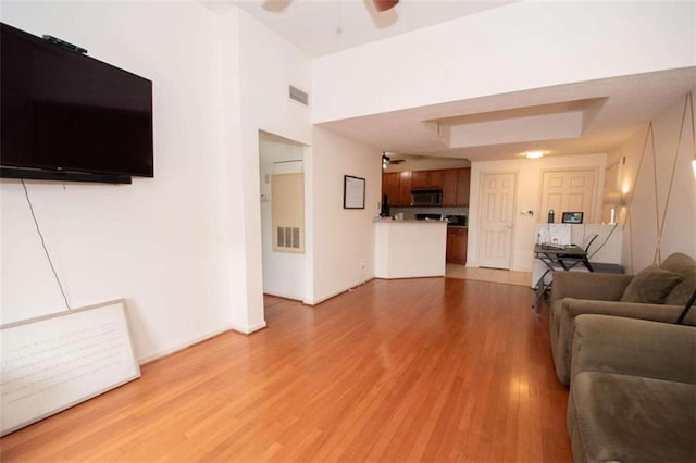 living room featuring ceiling fan and light hardwood / wood-style flooring