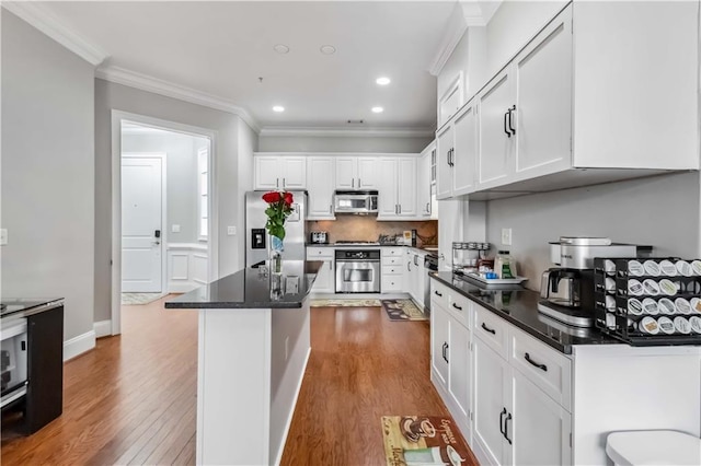 2300 Peachford Rd Unit 1410, Atlanta, GA 30338 - kitchen featuring white cabinetry, crown molding, appliances with stainless steel finishes, and light hardwood / wood-style flooring