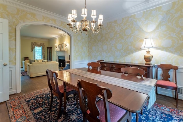 335 Cameron Ridge Dr, Atlanta, GA 30328 - dining area featuring crown molding, arched walkways, wallpapered walls, and wood finished floors