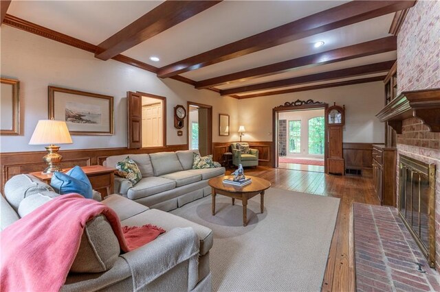 335 Cameron Ridge Dr, Atlanta, GA 30328 - living room featuring hardwood / wood-style floors, beam ceiling, ornamental molding, a fireplace, and wainscoting