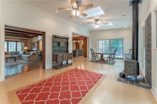 335 Cameron Ridge Dr, Atlanta, GA 30328 - living room featuring a skylight, crown molding, baseboards, ceiling fan, and a wood stove