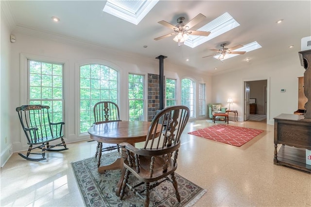335 Cameron Ridge Dr, Atlanta, GA 30328 - dining room with lofted ceiling with skylight, baseboards, ceiling fan, a wood stove, and ornamental molding