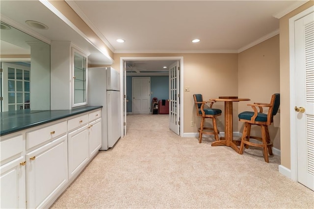 335 Cameron Ridge Dr, Atlanta, GA 30328 - interior space featuring freestanding refrigerator, dark countertops, glass insert cabinets, light carpet, and white cabinets