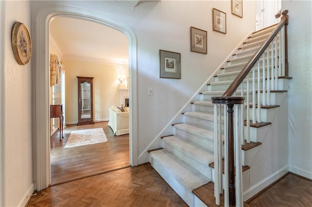 335 Cameron Ridge Dr, Atlanta, GA 30328 - stairs featuring ornamental molding, baseboards, parquet flooring, and arched walkways