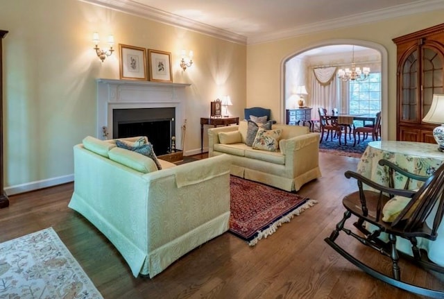 335 Cameron Ridge Dr, Atlanta, GA 30328 - living room featuring wood finished floors, ornamental molding, a fireplace, an inviting chandelier, and arched walkways