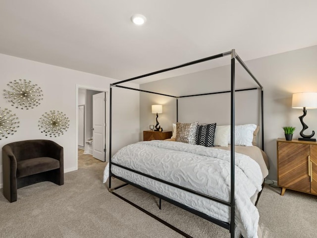 bedroom featuring carpet floors and connected bathroom