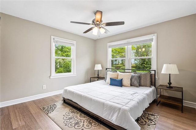 1623 Athens Ave SW, Atlanta, GA 30310 - bedroom featuring multiple windows, baseboards, a ceiling fan, and wood finished floors