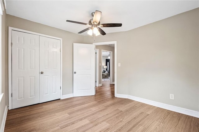 1623 Athens Ave SW, Atlanta, GA 30310 - unfurnished bedroom with a closet, baseboards, ceiling fan, and light wood-style floors