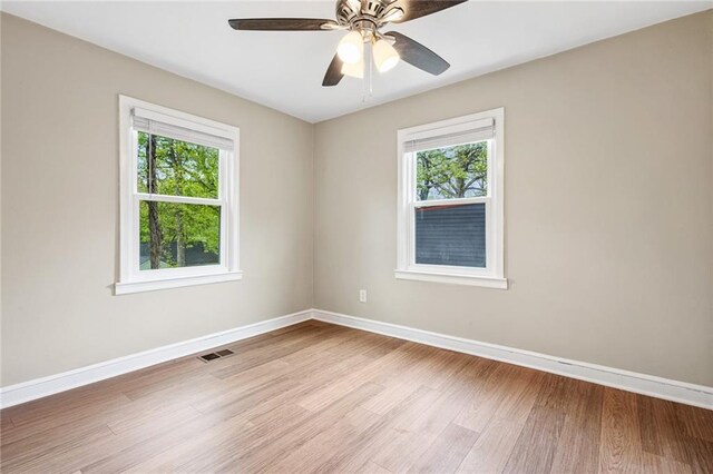 1623 Athens Ave SW, Atlanta, GA 30310 - empty room with visible vents, a wealth of natural light, light wood-style floors, and baseboards