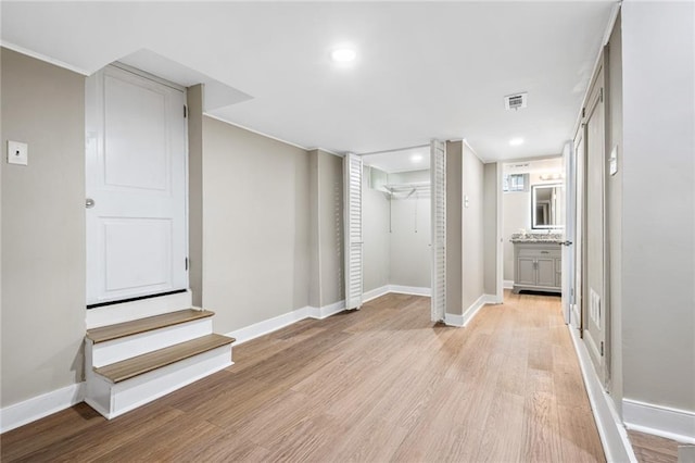 1623 Athens Ave SW, Atlanta, GA 30310 - finished below grade area featuring light wood-style floors, baseboards, visible vents, and stairway