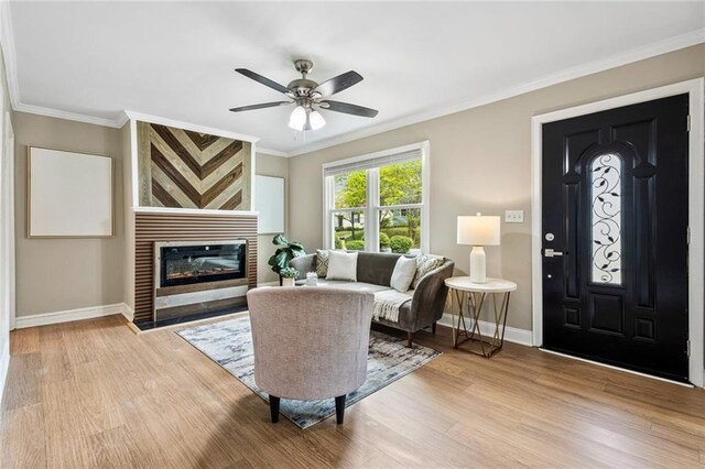 1623 Athens Ave SW, Atlanta, GA 30310 - living room with light wood-style flooring, crown molding, ceiling fan, and baseboards