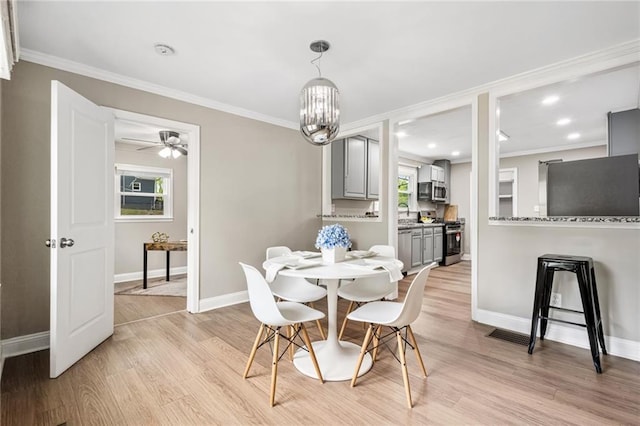 1623 Athens Ave SW, Atlanta, GA 30310 - dining room featuring crown molding, baseboards, and light wood-type flooring