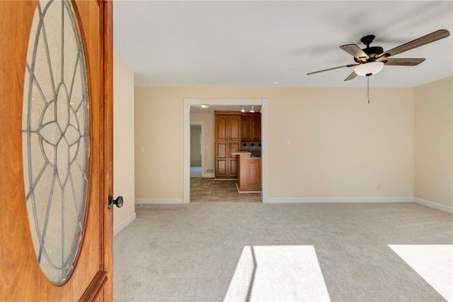 tiled empty room featuring ceiling fan