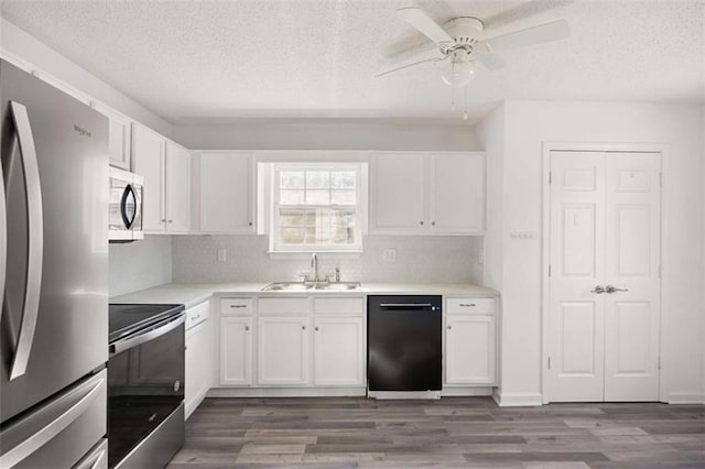 3645 Ten Oaks Cir, Powder Springs, GA 30127 - kitchen featuring stainless steel appliances, a sink, a textured ceiling, white cabinets, and dark wood-type flooring
