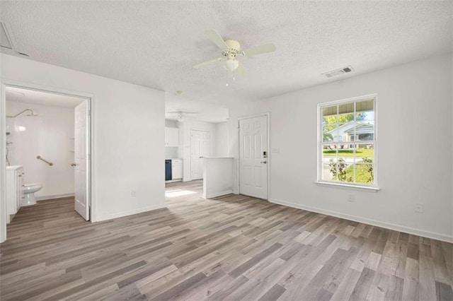 3645 Ten Oaks Cir, Powder Springs, GA 30127 - unfurnished living room with light wood-style floors, a textured ceiling, ceiling fan, and baseboards