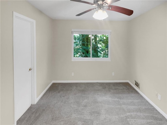 carpeted spare room with ceiling fan