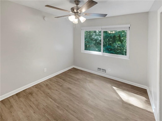 empty room featuring hardwood / wood-style flooring and ceiling fan