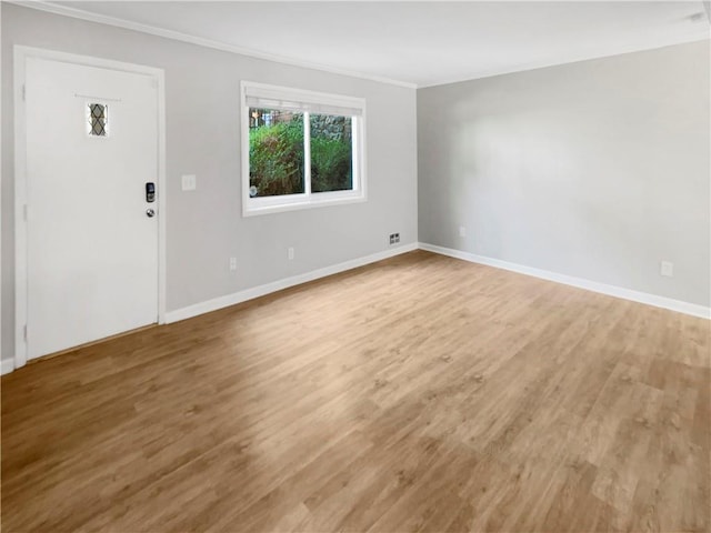 entrance foyer with hardwood / wood-style flooring and crown molding