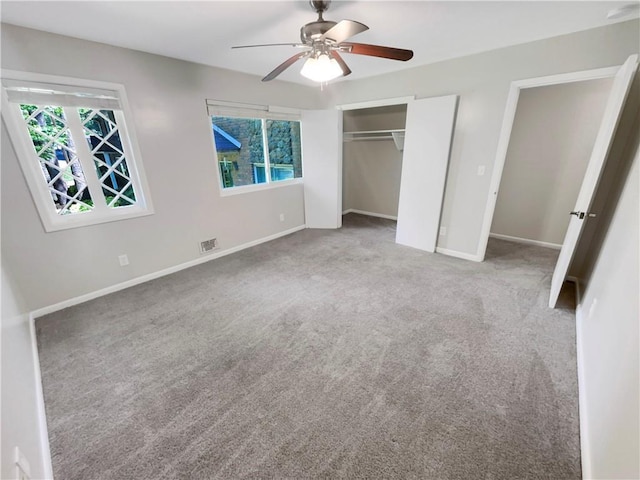 unfurnished bedroom featuring carpet, a closet, and ceiling fan