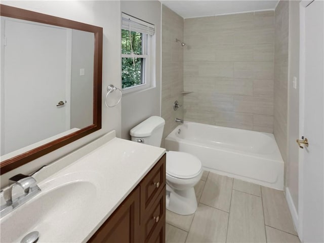 full bathroom featuring tile patterned flooring, vanity, toilet, and tiled shower / bath