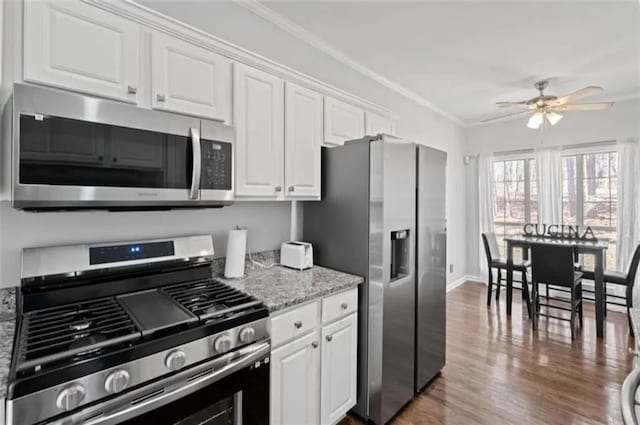 4021 Melvin Dr SW, Atlanta, GA 30331 - kitchen featuring stainless steel appliances, ceiling fan, crown molding, white cabinetry, and wood finished floors